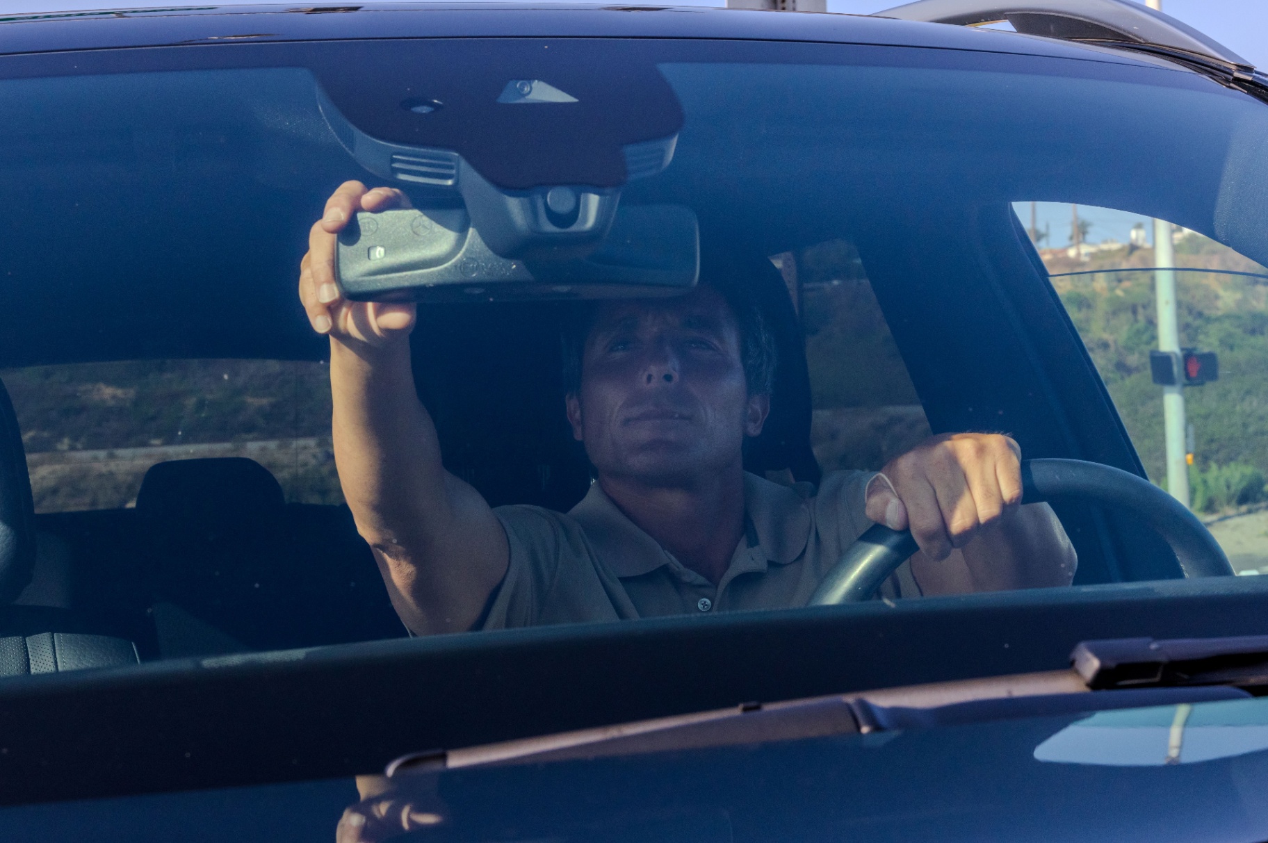 Valet attendant adjusting the mirror before parking a guest's car